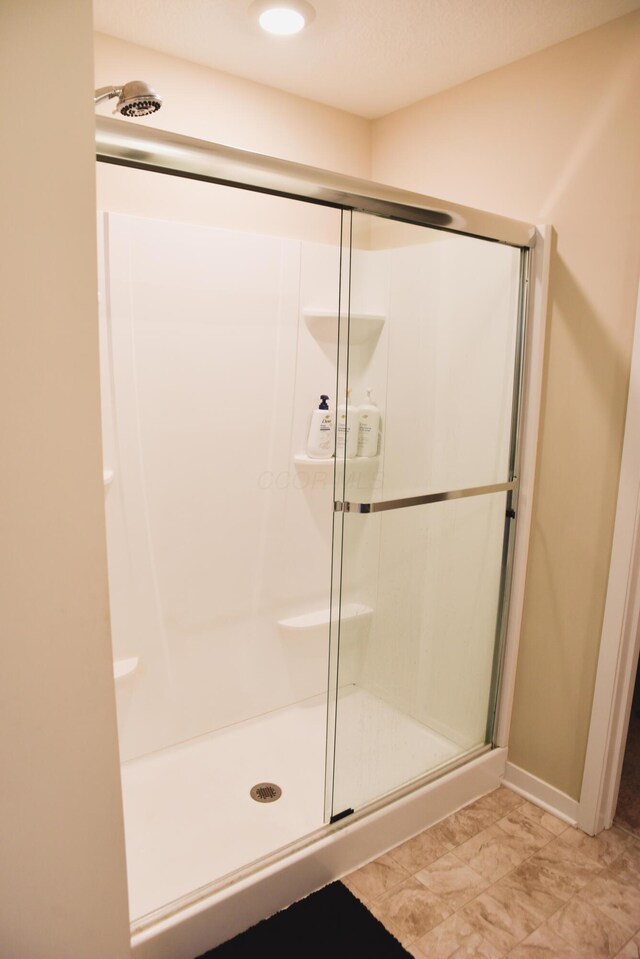 1151 Gelbray Dr, Columbus, OH 43207 - full bath with baseboards, a shower stall, and marble finish floor