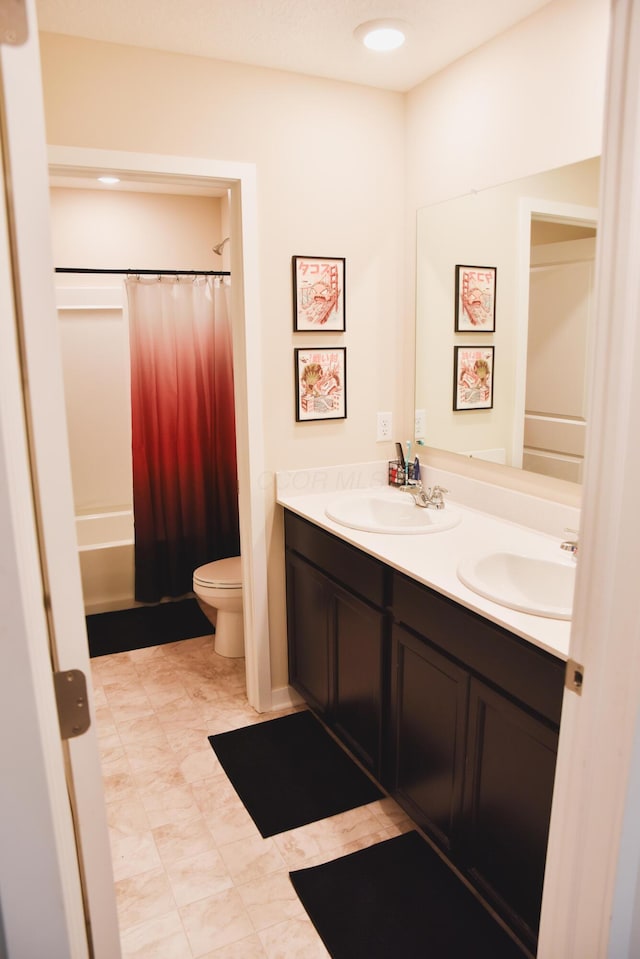 1151 Gelbray Dr, Columbus, OH 43207 - full bath featuring double vanity, toilet, a sink, and shower / bath combo with shower curtain
