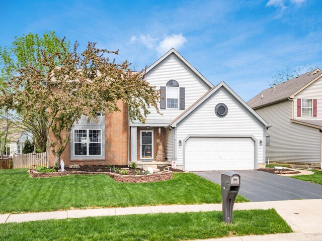 6008 Macnabb Ct, Hilliard, OH 43026 - traditional-style house featuring fence, a front lawn, brick siding, a garage, and aphalt driveway