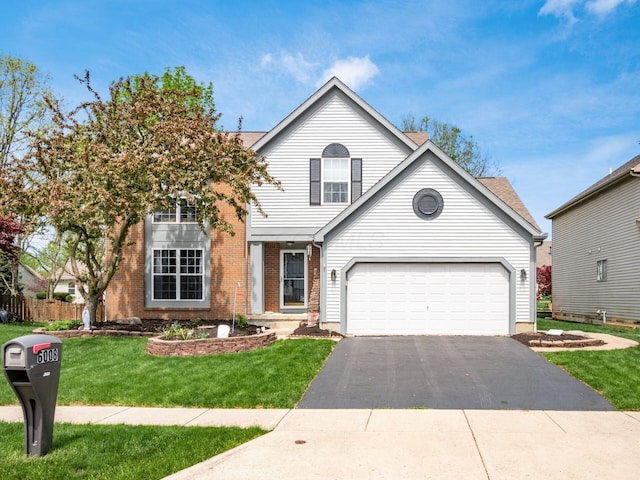 6008 Macnabb Ct, Hilliard, OH 43026 - traditional-style home with a front yard, driveway, and brick siding