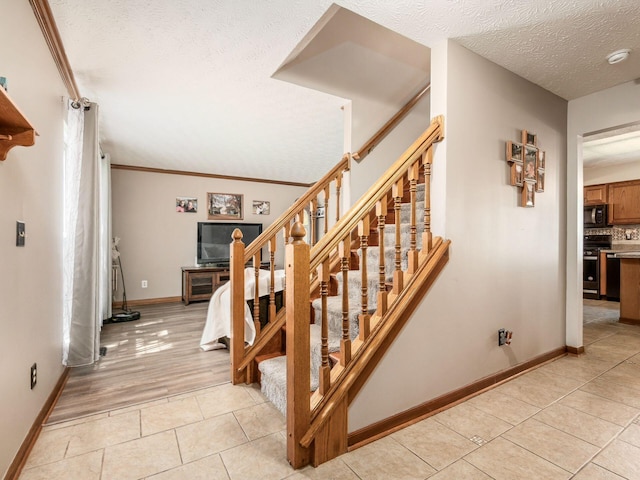 6008 Macnabb Ct, Hilliard, OH 43026 - stairway with baseboards, a textured ceiling, crown molding, and tile patterned floors