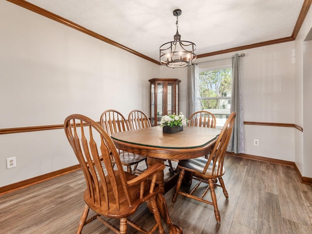 6008 Macnabb Ct, Hilliard, OH 43026 - dining room featuring an inviting chandelier, crown molding, and wood finished floors