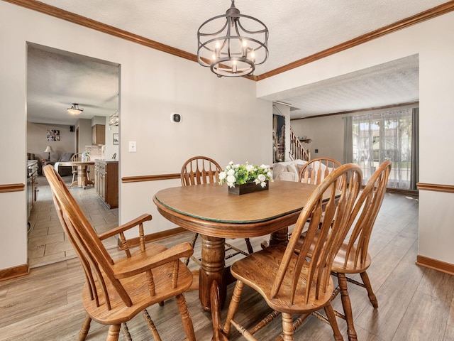 6008 Macnabb Ct, Hilliard, OH 43026 - dining space featuring baseboards, a textured ceiling, stairway, and an inviting chandelier