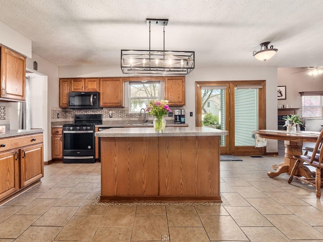 6008 Macnabb Ct, Hilliard, OH 43026 - kitchen featuring a healthy amount of sunlight, decorative backsplash, a sink, and black appliances