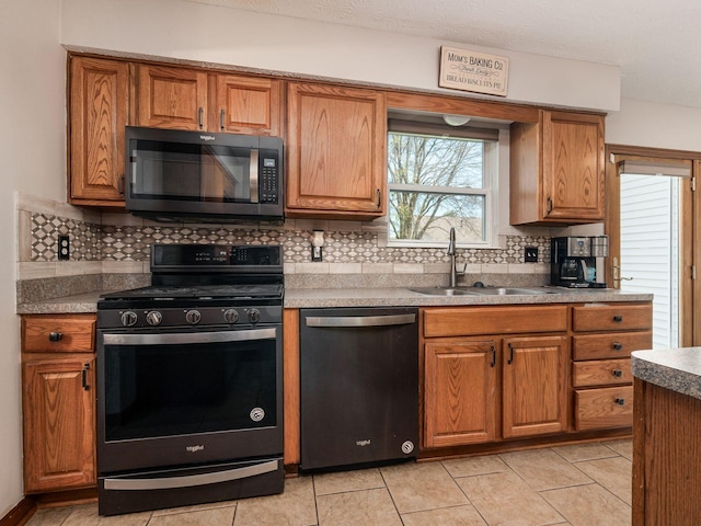 6008 Macnabb Ct, Hilliard, OH 43026 - kitchen with a sink, decorative backsplash, stainless steel appliances, and brown cabinets
