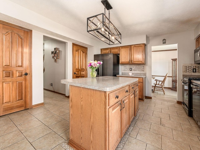 6008 Macnabb Ct, Hilliard, OH 43026 - kitchen with decorative backsplash, a kitchen island, light countertops, light tile patterned floors, and stainless steel appliances