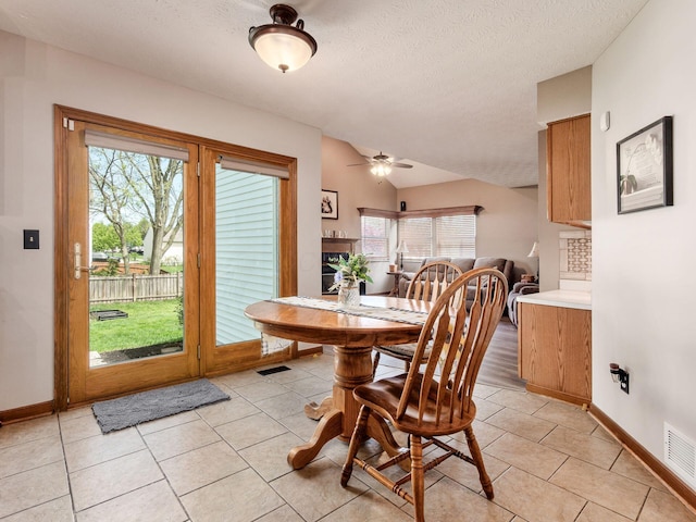 6008 Macnabb Ct, Hilliard, OH 43026 - dining space with baseboards, a ceiling fan, a textured ceiling, and vaulted ceiling