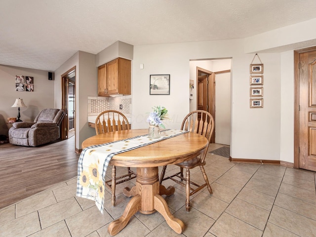 6008 Macnabb Ct, Hilliard, OH 43026 - dining room with a textured ceiling, baseboards, and light tile patterned flooring