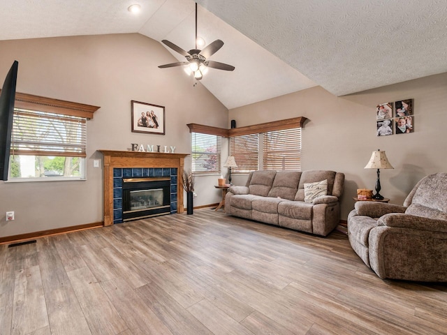 6008 Macnabb Ct, Hilliard, OH 43026 - living area featuring ceiling fan, baseboards, light wood-type flooring, a tile fireplace, and visible vents
