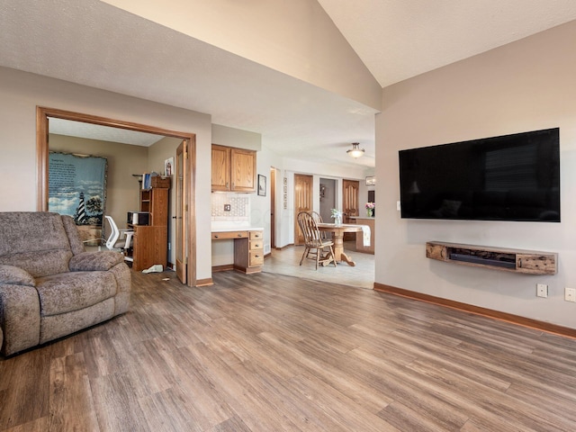 6008 Macnabb Ct, Hilliard, OH 43026 - living room with baseboards, vaulted ceiling, and light wood-style flooring
