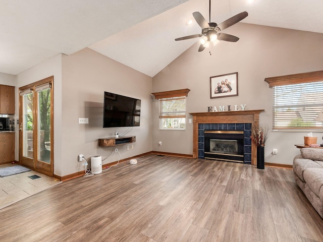 6008 Macnabb Ct, Hilliard, OH 43026 - unfurnished living room featuring baseboards, ceiling fan, wood finished floors, and a tile fireplace
