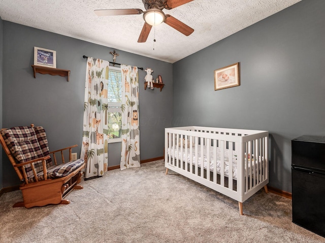6008 Macnabb Ct, Hilliard, OH 43026 - bedroom with carpet flooring, a crib, a textured ceiling, a ceiling fan, and baseboards