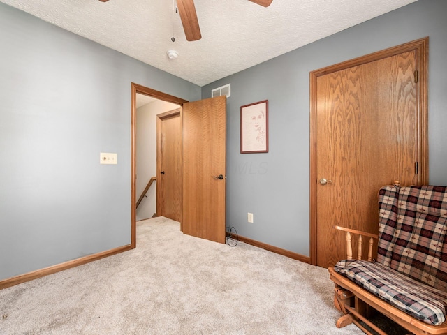 6008 Macnabb Ct, Hilliard, OH 43026 - sitting room with ceiling fan, visible vents, carpet floors, baseboards, and an upstairs landing