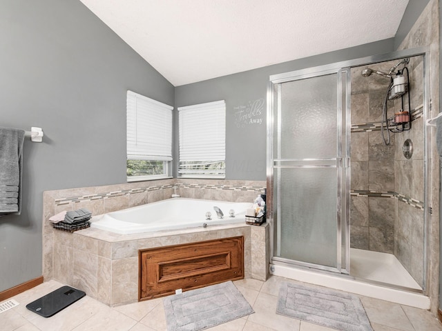 6008 Macnabb Ct, Hilliard, OH 43026 - bathroom with tile patterned floors, lofted ceiling, a shower stall, and a bath