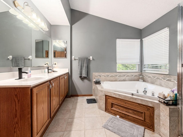 6008 Macnabb Ct, Hilliard, OH 43026 - full bath featuring tile patterned flooring, double vanity, a bath, a sink, and vaulted ceiling