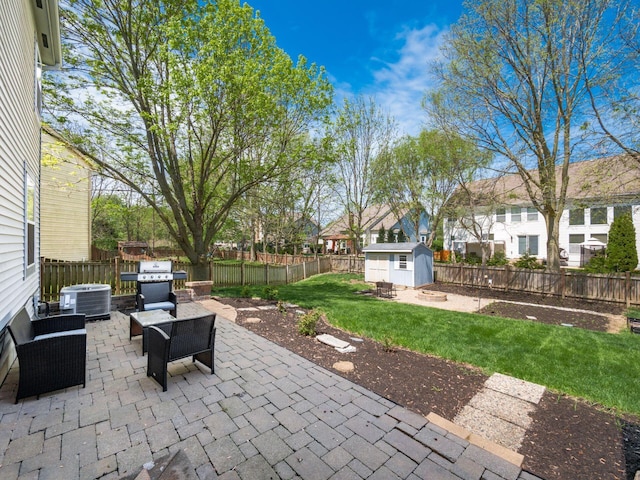 6008 Macnabb Ct, Hilliard, OH 43026 - view of patio / terrace featuring an outdoor structure, cooling unit, a grill, a fenced backyard, and a storage unit