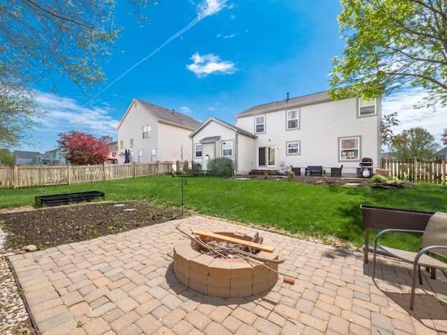 6008 Macnabb Ct, Hilliard, OH 43026 - rear view of property featuring a patio, a lawn, fence, and an outdoor fire pit