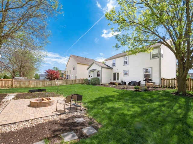 6008 Macnabb Ct, Hilliard, OH 43026 - rear view of property featuring a patio, a fenced backyard, entry steps, an outdoor fire pit, and a yard