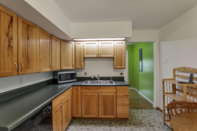 19361 White Stone Rd, Marysville, OH 43040 - kitchen featuring dark countertops, baseboards, stainless steel microwave, a sink, and dishwasher