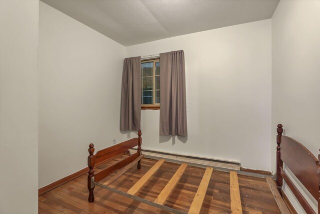 19361 White Stone Rd, Marysville, OH 43040 - unfurnished room featuring baseboards, wood-type flooring, a baseboard heating unit, and lofted ceiling