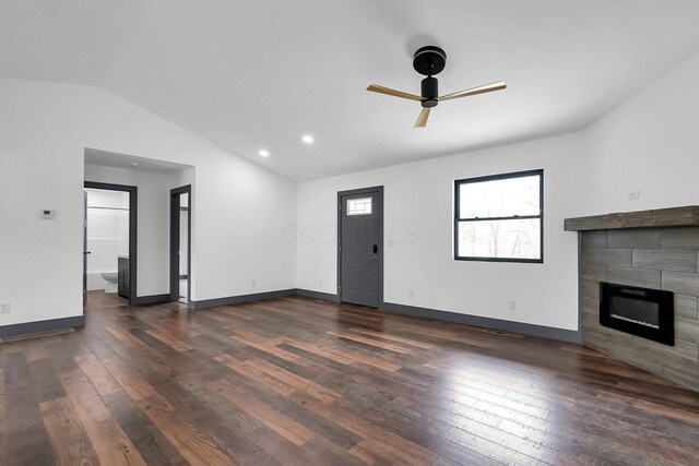 unfurnished living room with a tile fireplace, a ceiling fan, wood finished floors, and lofted ceiling