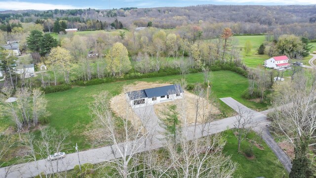 aerial view with a wooded view and a rural view