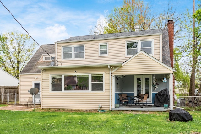 back of house with a chimney, fence, a patio, and a yard