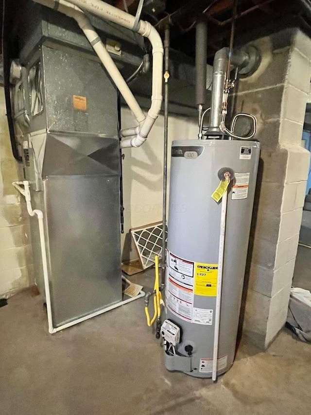 utility room with heating unit and water heater