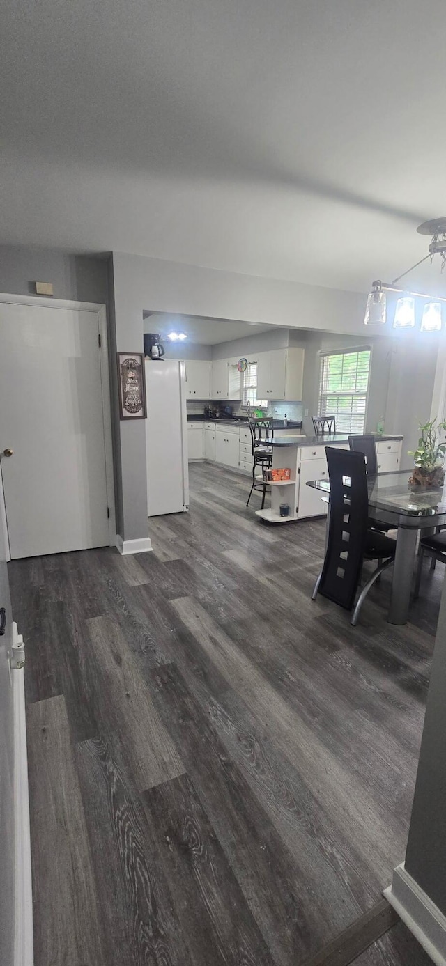 dining space featuring dark wood-style floors