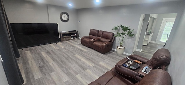 living area featuring baseboards, recessed lighting, and wood finished floors