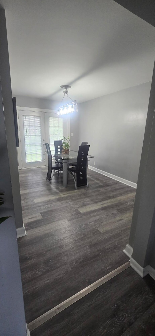 dining area with wood finished floors and baseboards
