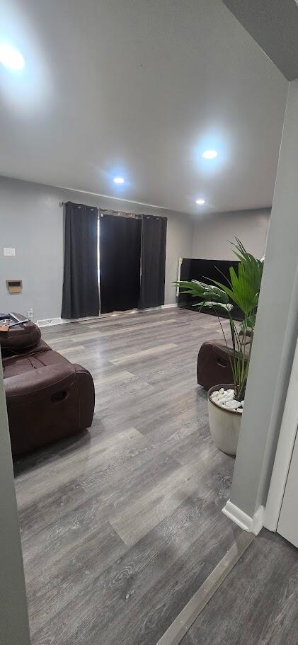 interior space with wood finished floors and recessed lighting