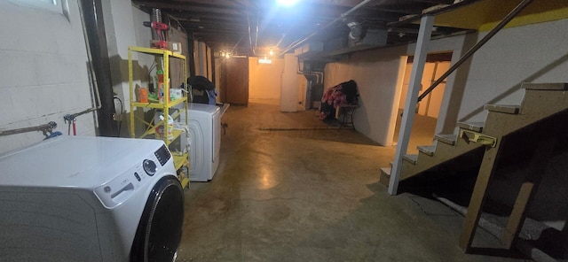 unfinished basement with stairs and washing machine and clothes dryer