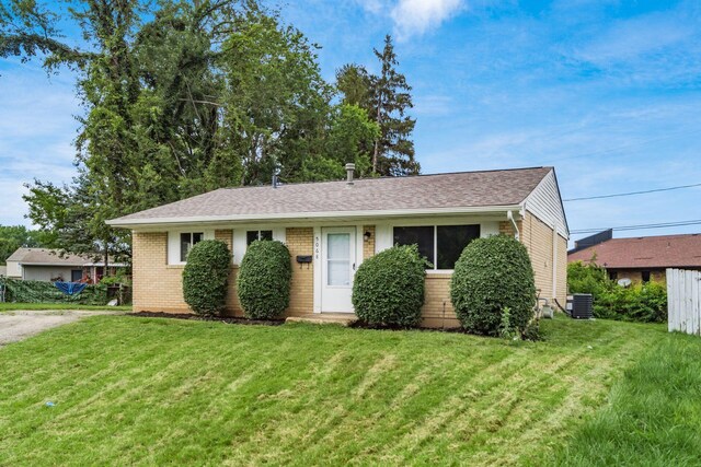 5068 Tremaine Ct, Columbus, OH 43232 - view of front facade featuring a front yard, brick siding, and a shingled roof