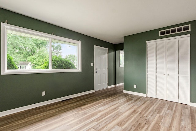 5068 Tremaine Ct, Columbus, OH 43232 - unfurnished bedroom featuring wood finished floors, multiple windows, and a closet