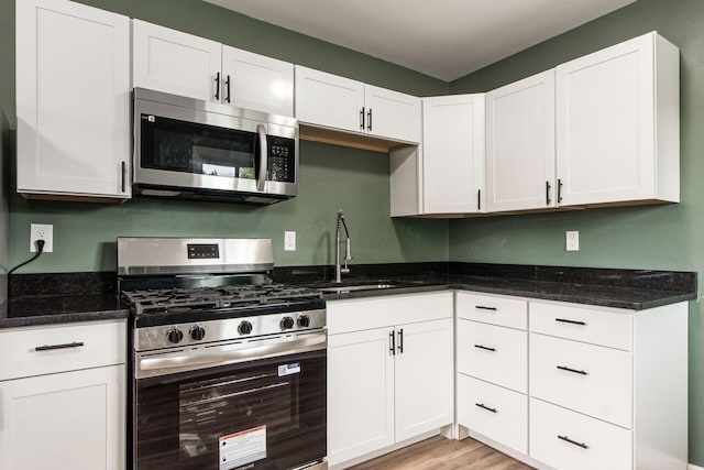 5068 Tremaine Ct, Columbus, OH 43232 - kitchen featuring appliances with stainless steel finishes, white cabinetry, and dark stone counters