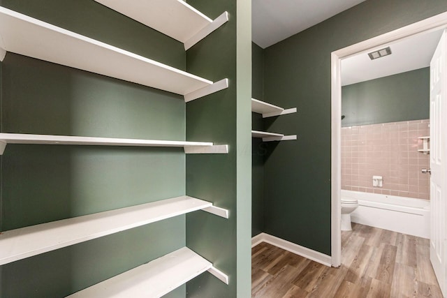 5068 Tremaine Ct, Columbus, OH 43232 - walk in closet featuring wood finished floors