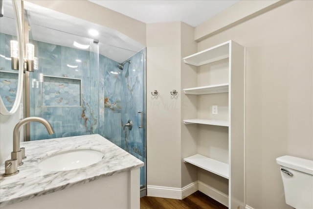 4096 Jonquil St, Columbus, OH 43224 - bathroom featuring vanity, wood finished floors, toilet, baseboards, and a stall shower