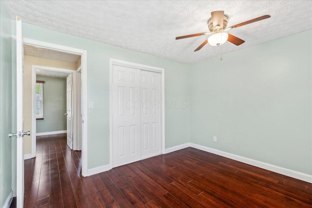 4096 Jonquil St, Columbus, OH 43224 - unfurnished bedroom featuring wood-type flooring, a textured ceiling, baseboards, and a closet