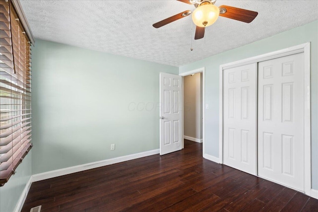 4096 Jonquil St, Columbus, OH 43224 - unfurnished bedroom with dark wood-type flooring, a textured ceiling, baseboards, and a closet