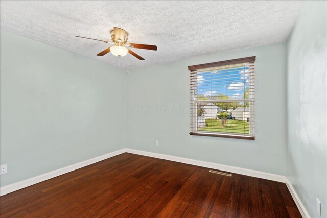 4096 Jonquil St, Columbus, OH 43224 - unfurnished room with baseboards, a ceiling fan, dark wood-style flooring, and a textured ceiling