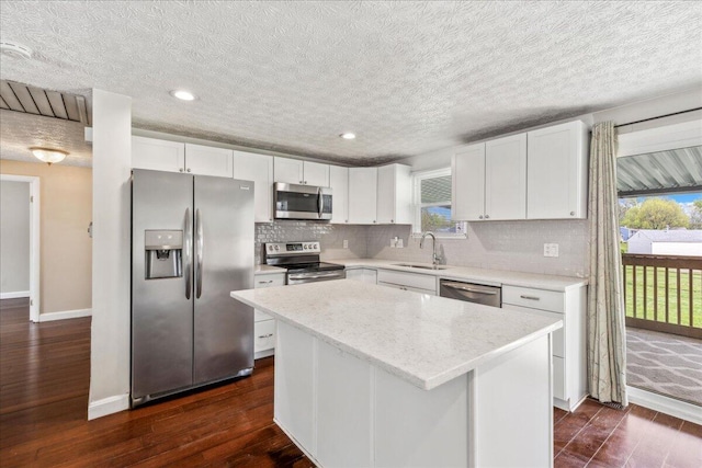 4096 Jonquil St, Columbus, OH 43224 - kitchen featuring a sink, a kitchen island, a healthy amount of sunlight, and stainless steel appliances