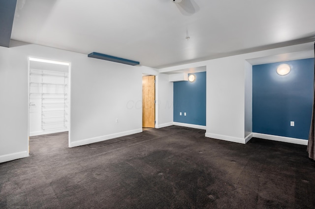 unfurnished living room featuring baseboards and carpet