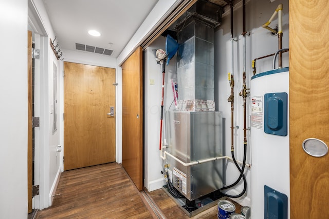 utilities with visible vents and electric water heater