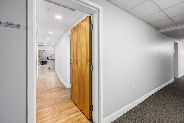 hall with recessed lighting, baseboards, and visible vents