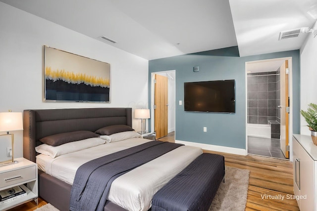 106 N High St Unit 104, Columbus, OH 43215 - bedroom featuring baseboards, wood finished floors, and visible vents