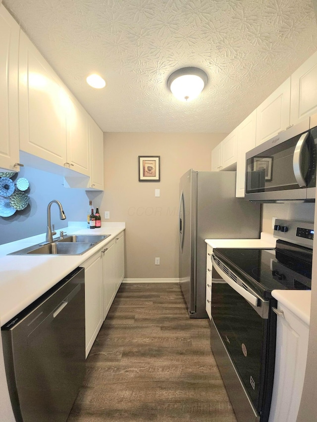 6682 Lagrange Dr Unit 48B, Canal Winchester, OH 43110 - kitchen with appliances with stainless steel finishes, dark wood finished floors, a sink, light countertops, and white cabinets