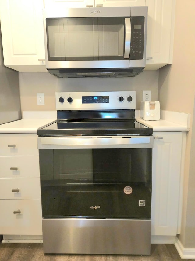 6682 Lagrange Dr Unit 48B, Canal Winchester, OH 43110 - interior details featuring white cabinets, appliances with stainless steel finishes, wood finished floors, and light countertops