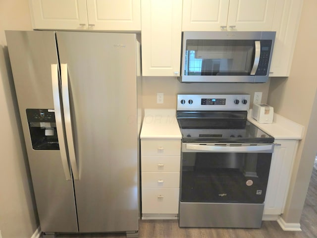 6682 Lagrange Dr Unit 48B, Canal Winchester, OH 43110 - kitchen featuring light countertops, stainless steel appliances, wood finished floors, and white cabinetry
