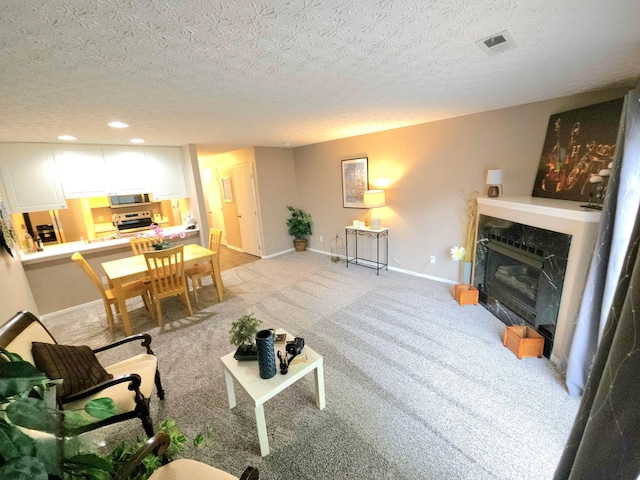 6682 Lagrange Dr Unit 48B, Canal Winchester, OH 43110 - living room featuring visible vents, baseboards, recessed lighting, a high end fireplace, and a textured ceiling